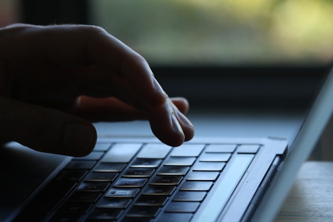 programmer coding on laptop