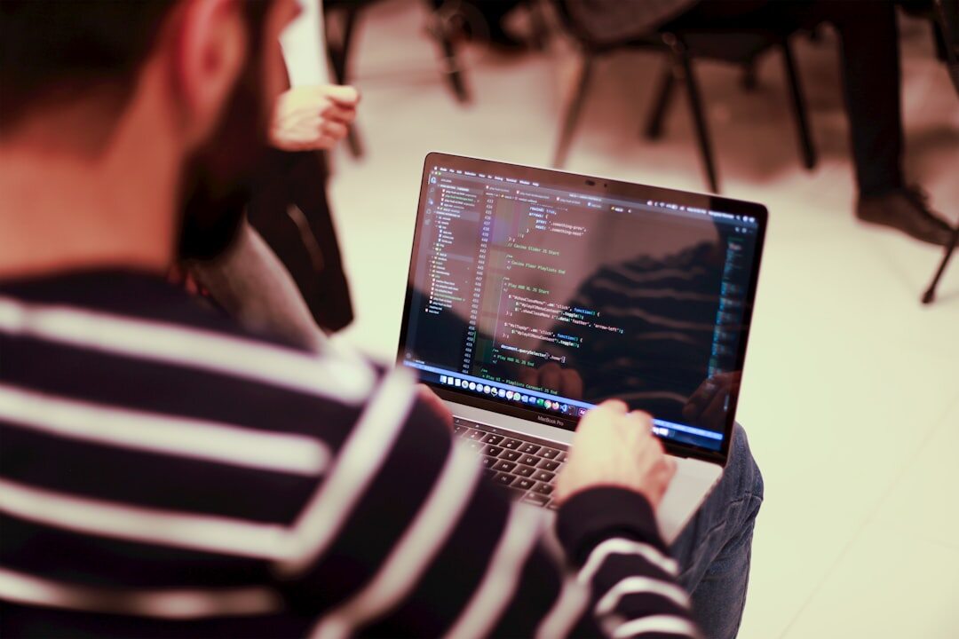 web developer typing code on laptop
