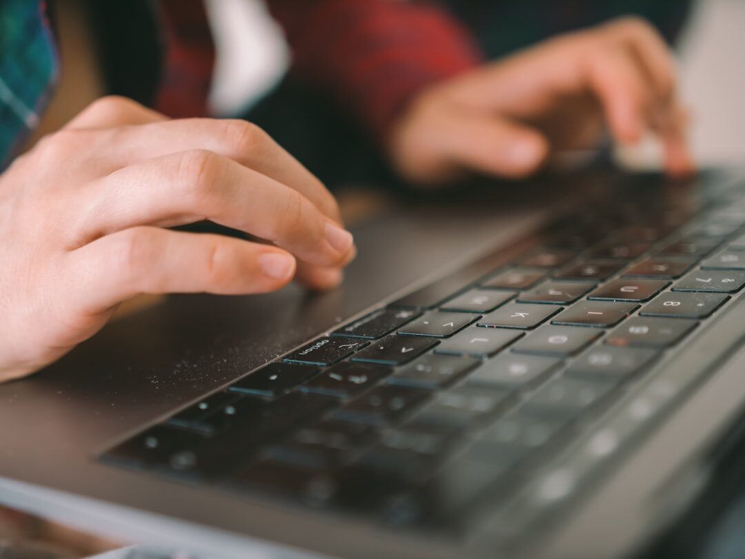 web developer typing code on laptop
