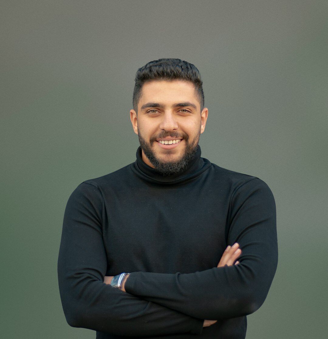 Studio portrait of a smiling man with short beard