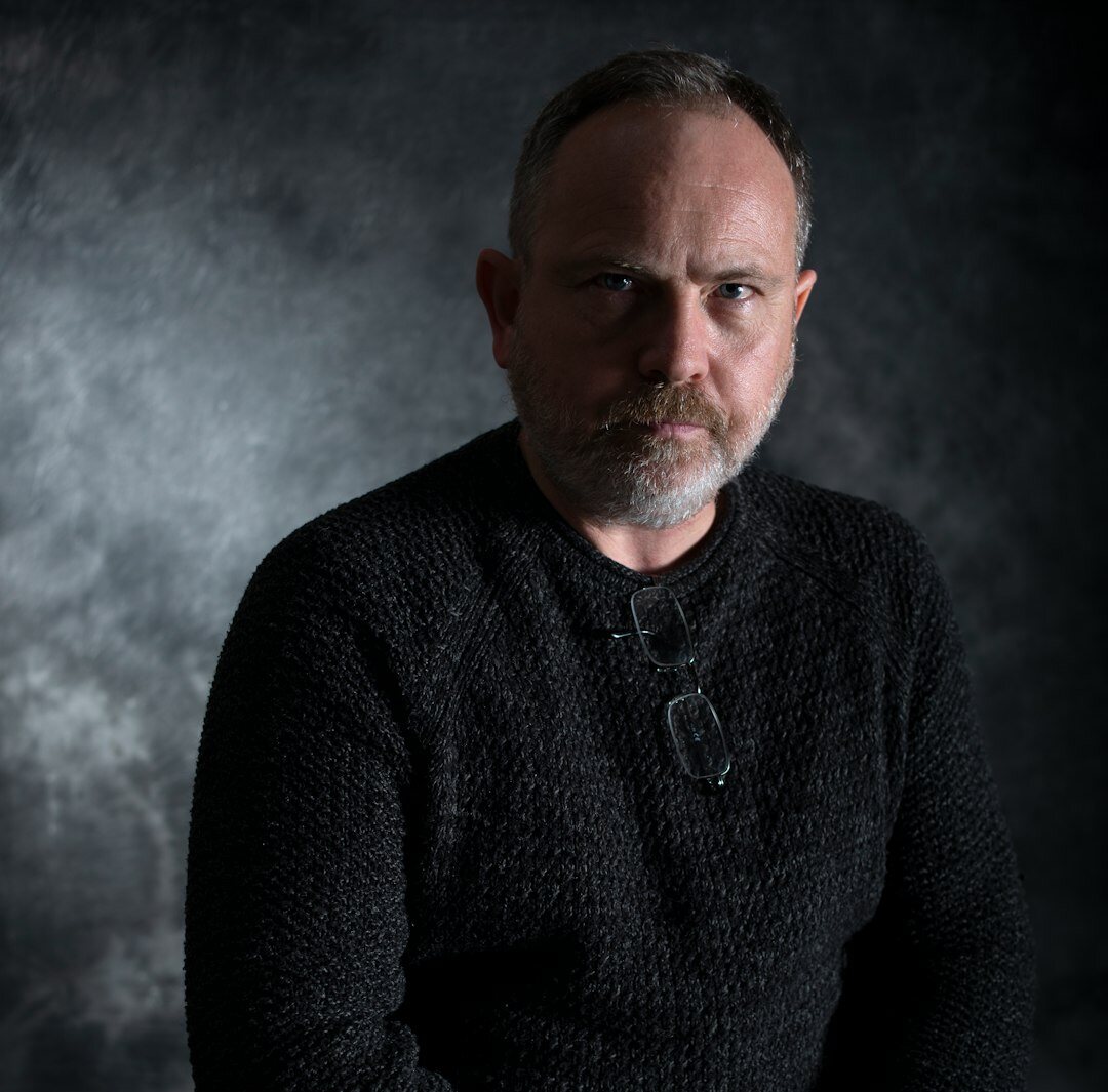 Studio portrait of an older man with gray hair
