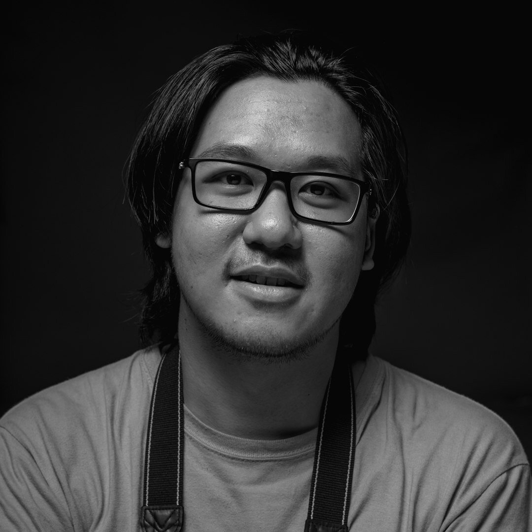 Studio portrait of a young man with glasses