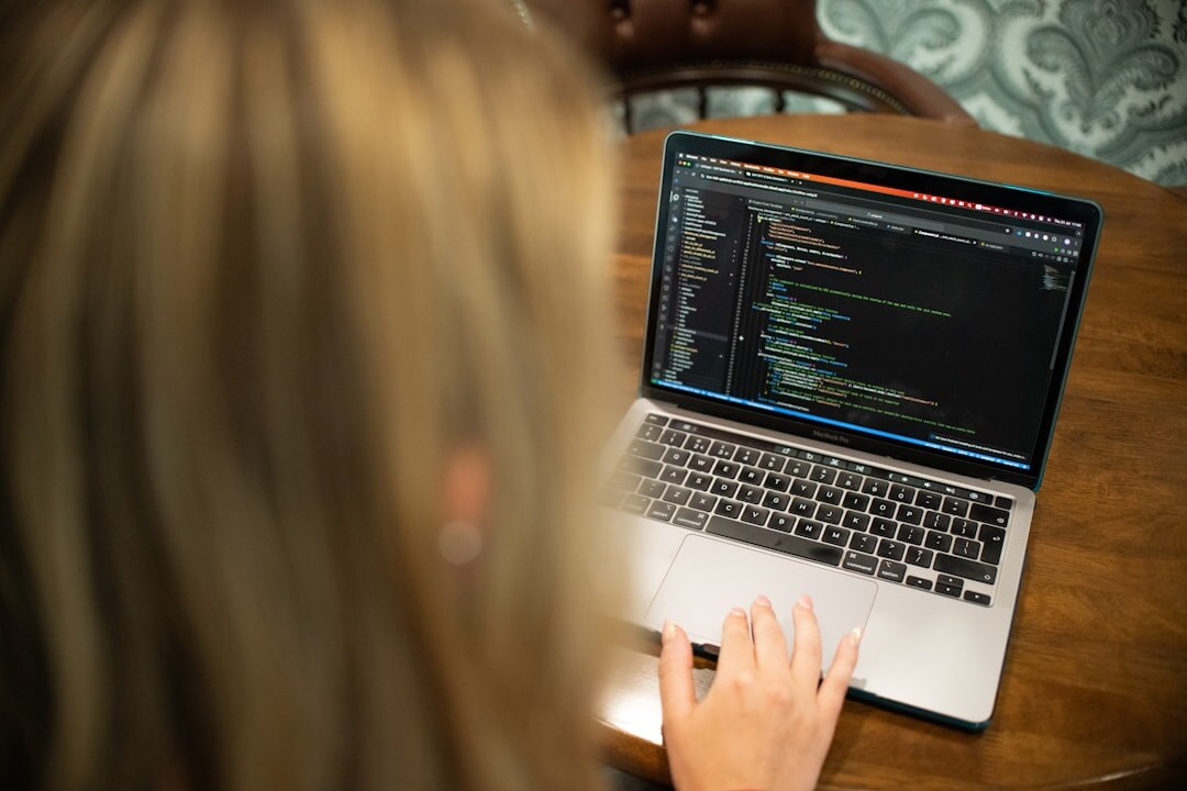 person coding on laptop