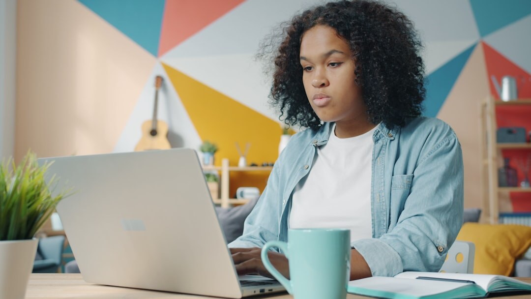 person writing on laptop
